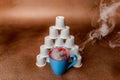 Steaming Coffee and Pod Pyramid Copper Background Angled View. Royalty Free Stock Photo