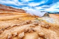 Steaming cone in Hverir geothermal area with boiling mudpools and steaming fumaroles in Iceland Royalty Free Stock Photo