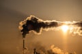 Steaming cooling towers and smoking industrial stacks against sunset gradient sky Royalty Free Stock Photo