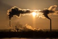 Steaming cooling towers and smoking industrial stacks against sunset gradient sky Royalty Free Stock Photo