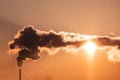 Steaming cooling towers and smoking industrial stacks against sunset gradient sky Royalty Free Stock Photo