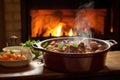 steaming coq au vin on a wooden dining table