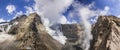 Steaming crater of active volcano covered by snow