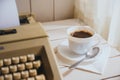 Vintage looking coffee and typing machine on a desk
