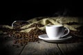 Steaming cup of coffee on wooden background