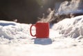 Steaming cup of hot coffee,tea or chocolatemilk in the cold fresh white snow, Winter,cozy,drink,snowy day concept Royalty Free Stock Photo