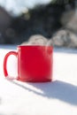 Steaming cup of hot coffee,tea or chocolatemilk in the cold fresh white snow, Winter,cozy,drink,snowy day concept Royalty Free Stock Photo