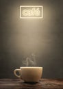 Steaming cup with illuminated cafÃÂ© sign