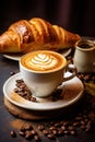 A steaming cup of rich and aromatic coffee, with creamy latte art swirling on top, on a table with a plate of buttery croissants