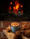 Sahlab drink served in a cozy winter scene with fireplace, topped with cinnamon and sugar, classic Arabic beverage Royalty Free Stock Photo