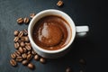 Steaming espresso served in cup on dark