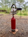 Steaming food in the forest. tea on a portable gas stove outdoors. Preparing breakfast for a picnic during a hike Royalty Free Stock Photo