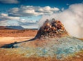 Steaming fumarole in geothermal Hverarond valley. Spectacular summer scene of outskirs of Reykjahlid village. Royalty Free Stock Photo