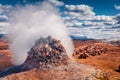 Steaming fumarole in geothermal valley Hverarond, Reykjahlid village location. Royalty Free Stock Photo