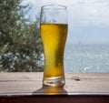 A steaming glass of beer stands on the bar