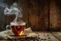 Steaming heart-shaped tea bag in a glass cup surrounded by coffee beans Royalty Free Stock Photo