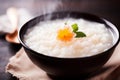 Steaming hot bowl of rice porridge with a flower garnish