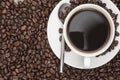 Steaming hot cup of coffee and beans Royalty Free Stock Photo