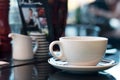 Steaming hot drink in a white cup on a cafe table. Royalty Free Stock Photo