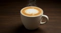 Steaming Latte in White Mug on Dark Wood Table Royalty Free Stock Photo