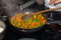 Steaming mixed vegetables in the pan cooking vegetarian and healthy