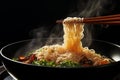 Steaming noodles on black background, held by chopsticks, a culinary delight