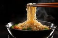 Steaming noodles on black background, held by chopsticks, a culinary delight