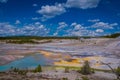 Steaming opaque thermal pools at Norris Geyser Basin. Yellowstone National Park, Wyoming, in beautiful blue sky and Royalty Free Stock Photo