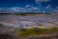 Steaming opaque thermal pools at Norris Geyser Basin. Yellowstone National Park, Wyoming, in beautiful blue sky and Royalty Free Stock Photo