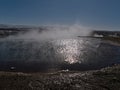 Steaming pool with hot thermal water in Geysir in geothermal area Haukadalur, part of Golden Circle, Iceland in winter. Royalty Free Stock Photo