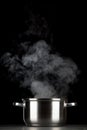 Steaming pot on black background Royalty Free Stock Photo