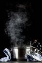 Steaming pot on black background Royalty Free Stock Photo