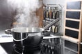 Steaming pot on electric stove in kitchen Royalty Free Stock Photo