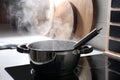 Steaming pot on electric stove in kitchen Royalty Free Stock Photo