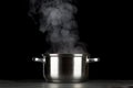 Steaming pot on black background Royalty Free Stock Photo