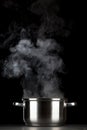 Steaming pot on black background Royalty Free Stock Photo