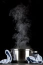 Steaming pot on black background Royalty Free Stock Photo