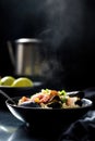Steaming seafood paella with vegetables in black bowl Royalty Free Stock Photo