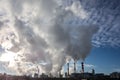 Steaming smoke stack and cooling tower with pollution