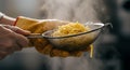 Steaming Spaghetti in Strainer Held by Hands Wearing Gloves Royalty Free Stock Photo