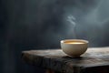 Steaming tea bowl on rustic wooden surface