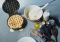 Steaming waffle iron making waffle, bowl of batter Royalty Free Stock Photo