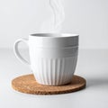 Steaming White Coffee Mug on Cork Coaster with Minimalist Backdrop Still Life Royalty Free Stock Photo