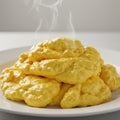 Steaming Yellow Scrambled Eggs on White Plate Royalty Free Stock Photo