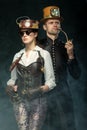 Steampunk couple. Man with a pipe and a girl with glasses and h Royalty Free Stock Photo