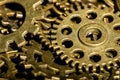 A steampunk macro of a pile of tiny industrial gears and wheels showing dirt and rust from past use