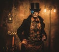 Steampunk man with gun on vintage steampunk background Royalty Free Stock Photo