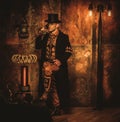 Steampunk man with Tesla coil on vintage steampunk background Royalty Free Stock Photo