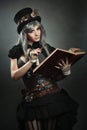 Steampunk scientist with book and lens Royalty Free Stock Photo