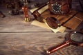 Steampunk still life - old vintage objects on a wooden background. Leather wrist watch, dark glasses, old tube lamps, magnifying g